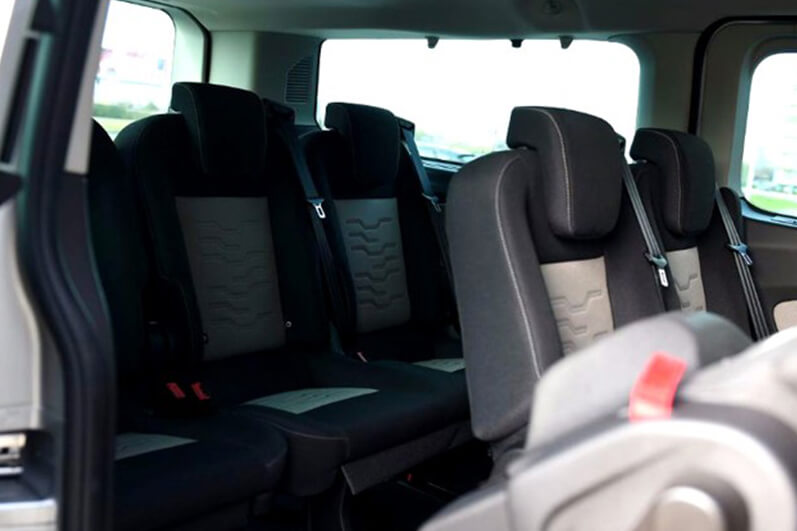 Rows of passenger seats in a Renault Trafic